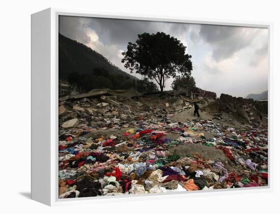 A Pakistani Refugee Walks Past Clothing Left Strewn on the Ground-null-Framed Premier Image Canvas