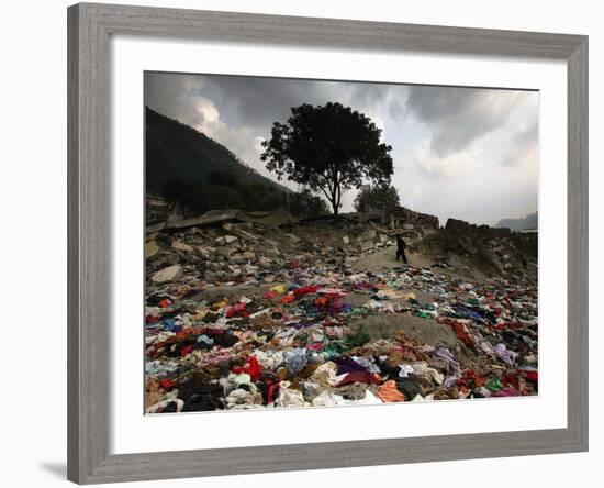 A Pakistani Refugee Walks Past Clothing Left Strewn on the Ground-null-Framed Photographic Print