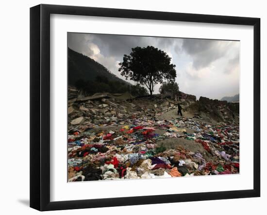 A Pakistani Refugee Walks Past Clothing Left Strewn on the Ground-null-Framed Photographic Print