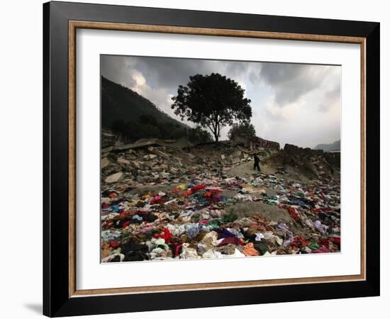 A Pakistani Refugee Walks Past Clothing Left Strewn on the Ground-null-Framed Photographic Print