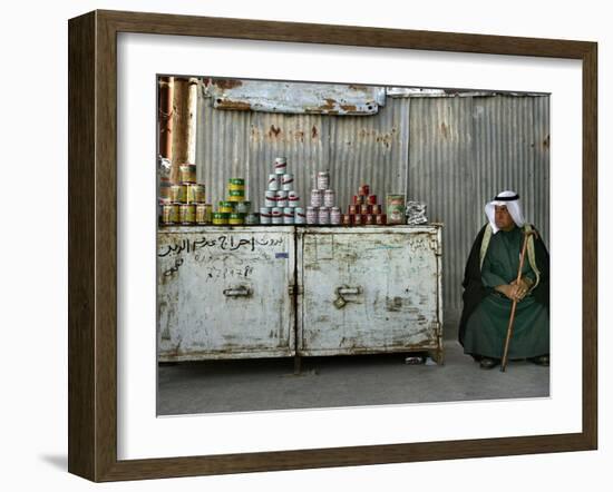 A Palestinian Sits Near the Stand of a Street Seller Displaying Goods for Sale-null-Framed Photographic Print