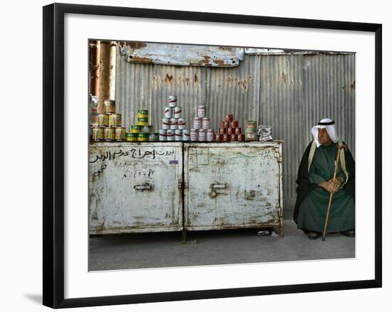 A Palestinian Sits Near the Stand of a Street Seller Displaying Goods for Sale-null-Framed Photographic Print