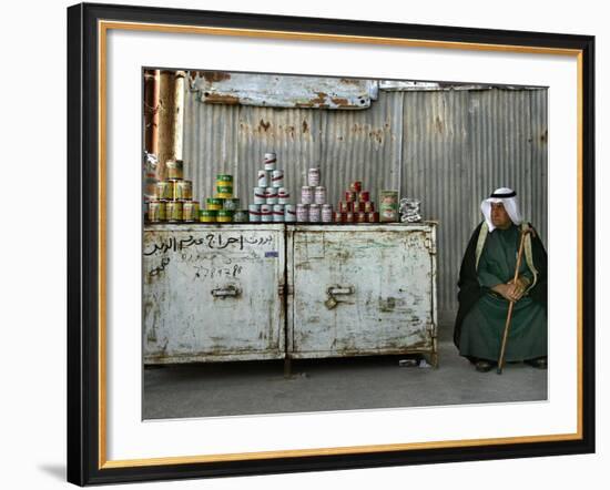 A Palestinian Sits Near the Stand of a Street Seller Displaying Goods for Sale-null-Framed Photographic Print