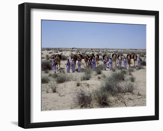 A party of Bedouin leading their camels in the desert-Werner Forman-Framed Giclee Print