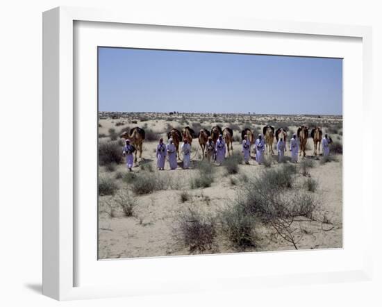 A party of Bedouin leading their camels in the desert-Werner Forman-Framed Giclee Print