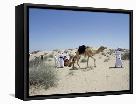 A party of Bedouin leading their camels in the desert-Werner Forman-Framed Premier Image Canvas