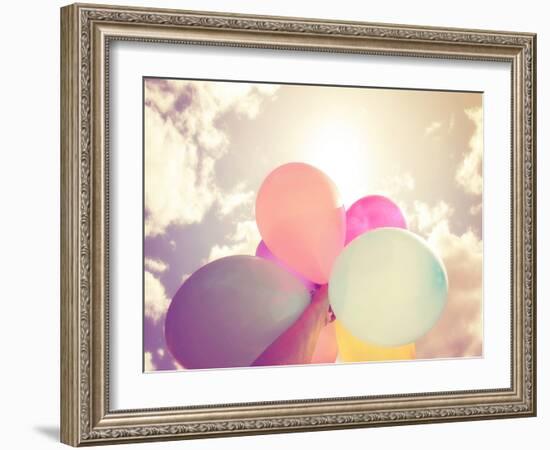 A Person Holding Multi Colored Balloons Done with a Retro Vintage Instagram Filter Effect-graphicphoto-Framed Photographic Print