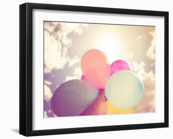 A Person Holding Multi Colored Balloons Done with a Retro Vintage Instagram Filter Effect-graphicphoto-Framed Photographic Print