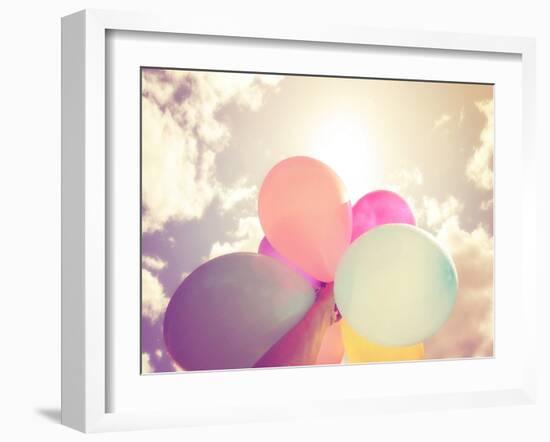 A Person Holding Multi Colored Balloons Done with a Retro Vintage Instagram Filter Effect-graphicphoto-Framed Photographic Print