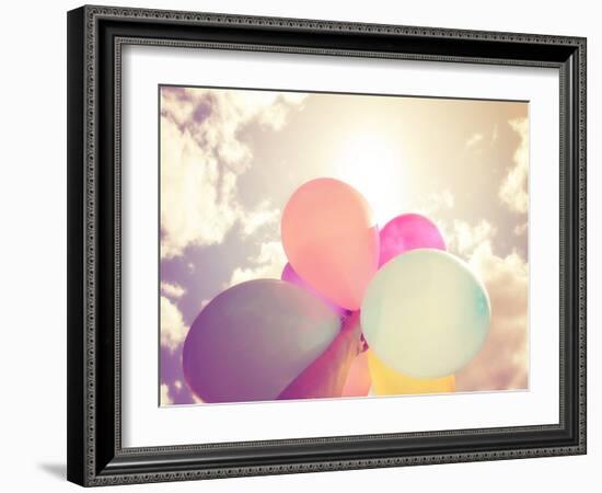 A Person Holding Multi Colored Balloons Done with a Retro Vintage Instagram Filter Effect-graphicphoto-Framed Photographic Print