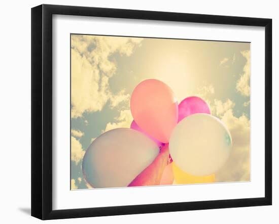 A Person Holding Multi Colored Balloons Done with a Retro Vintage Instagram Filter-graphicphoto-Framed Photographic Print