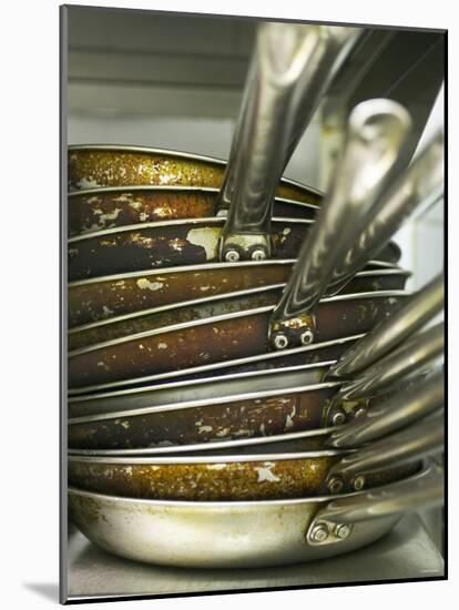 A Pile of Frying Pans in a Commercial Kitchen-Herbert Lehmann-Mounted Photographic Print