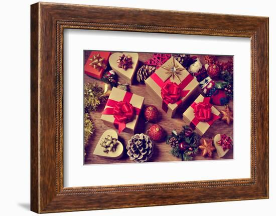 A Pile of Gifts and Christmas Ornaments, such as Christmas Balls, Stars and Tinsel, on a Rustic Woo-nito-Framed Photographic Print