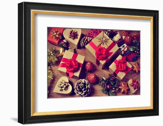 A Pile of Gifts and Christmas Ornaments, such as Christmas Balls, Stars and Tinsel, on a Rustic Woo-nito-Framed Photographic Print