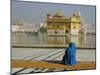 A Pilgrim in Blue Sits by the Holy Pool of Nectar at the Golden Temple, Punjab, India-Jeremy Bright-Mounted Photographic Print
