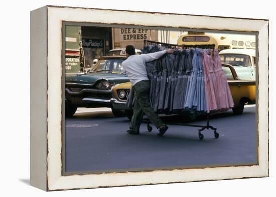 A Push Boy Steers a Rack of Dresses across an Intersection, New York, New York, 1960-Walter Sanders-Framed Premier Image Canvas