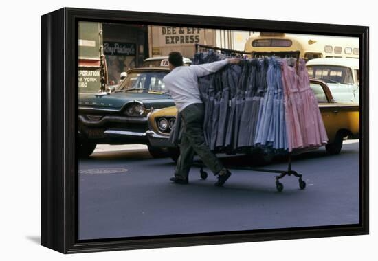 A Push Boy Steers a Rack of Dresses across an Intersection, New York, New York, 1960-Walter Sanders-Framed Premier Image Canvas