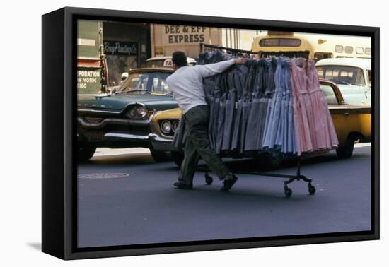 A Push Boy Steers a Rack of Dresses across an Intersection, New York, New York, 1960-Walter Sanders-Framed Premier Image Canvas