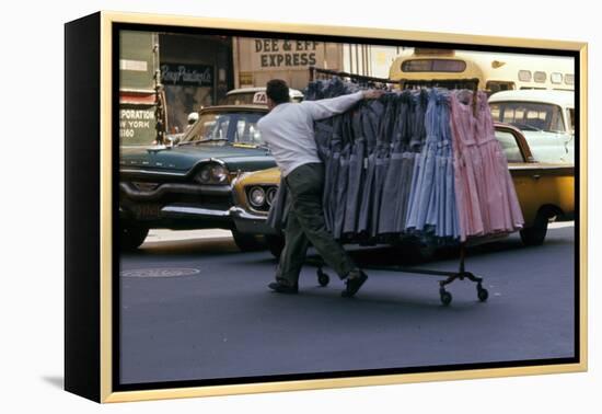 A Push Boy Steers a Rack of Dresses across an Intersection, New York, New York, 1960-Walter Sanders-Framed Premier Image Canvas