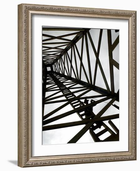 A Reenactor is Silhouetted Inside a Replica of the Spindletop Oil Derrick-null-Framed Photographic Print