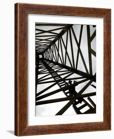 A Reenactor is Silhouetted Inside a Replica of the Spindletop Oil Derrick-null-Framed Photographic Print