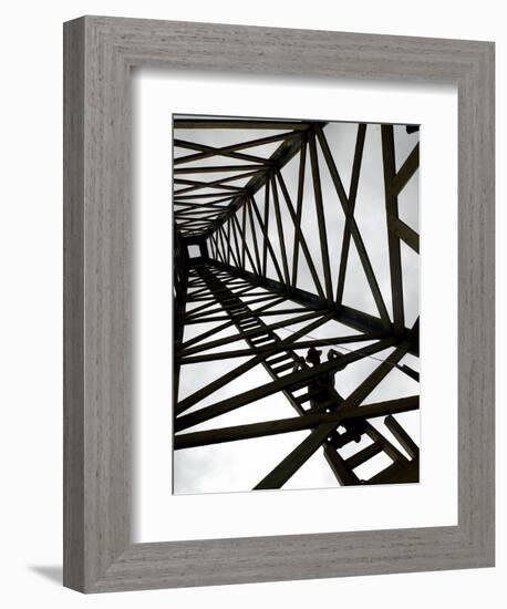 A Reenactor is Silhouetted Inside a Replica of the Spindletop Oil Derrick-null-Framed Photographic Print