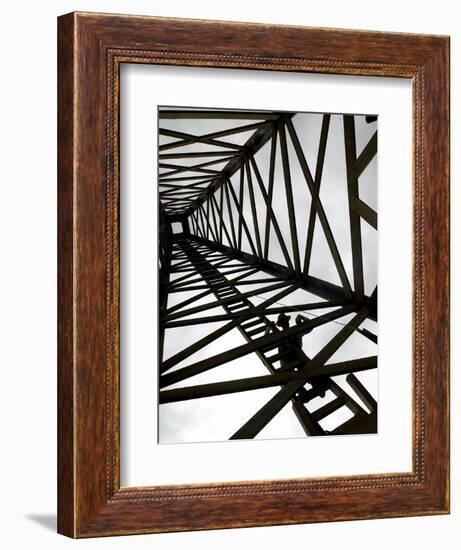 A Reenactor is Silhouetted Inside a Replica of the Spindletop Oil Derrick--Framed Photographic Print