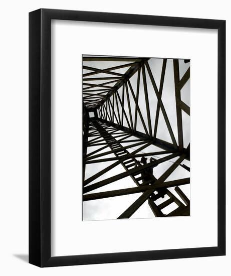 A Reenactor is Silhouetted Inside a Replica of the Spindletop Oil Derrick-null-Framed Photographic Print