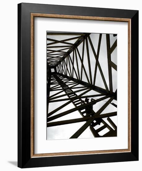 A Reenactor is Silhouetted Inside a Replica of the Spindletop Oil Derrick-null-Framed Photographic Print