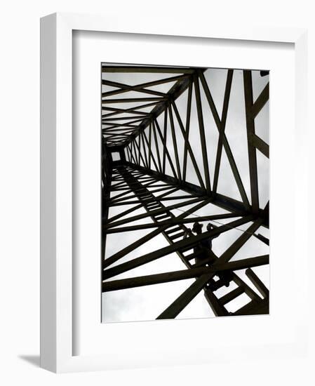 A Reenactor is Silhouetted Inside a Replica of the Spindletop Oil Derrick-null-Framed Photographic Print