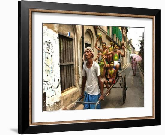 A Rickshaw Puller Carries Supporters of Brazil Soccer Team-null-Framed Photographic Print