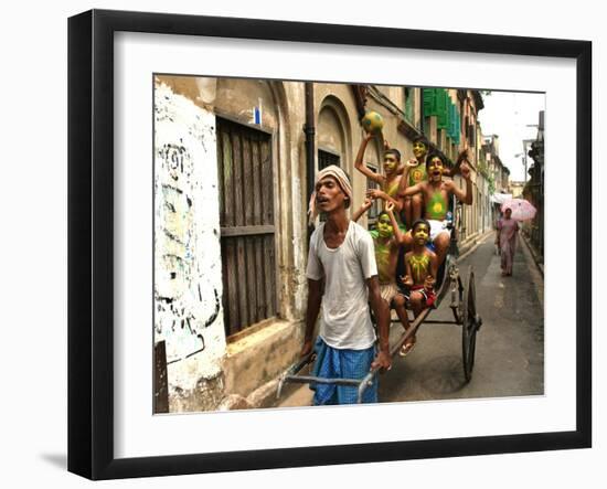 A Rickshaw Puller Carries Supporters of Brazil Soccer Team-null-Framed Photographic Print