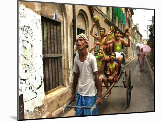 A Rickshaw Puller Carries Supporters of Brazil Soccer Team-null-Mounted Photographic Print