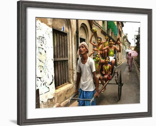 A Rickshaw Puller Carries Supporters of Brazil Soccer Team-null-Framed Photographic Print