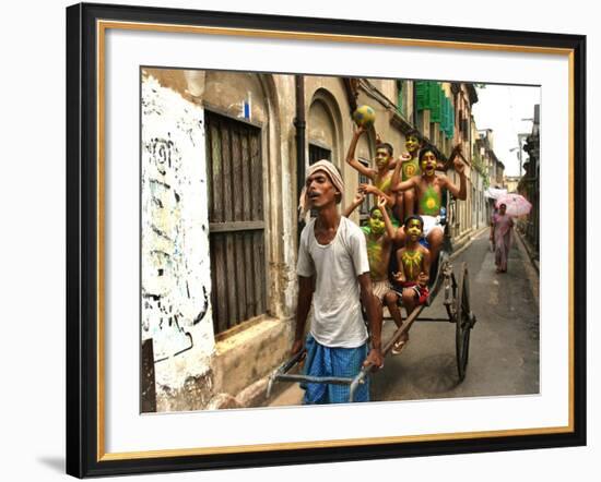 A Rickshaw Puller Carries Supporters of Brazil Soccer Team-null-Framed Photographic Print