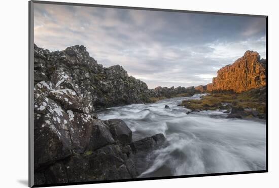 A river flows from the Oxarafoss waterfall at sunrise in Thingvellir National Park, UNESCO World He-Jon Reaves-Mounted Photographic Print