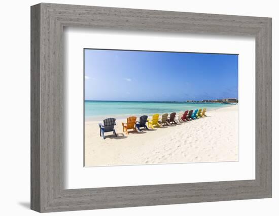 A Row of Colourful Wooden Deckchairs on Palm Beach, Aruba, Netherlands Antilles-Jane Sweeney-Framed Photographic Print