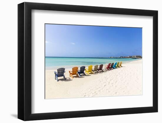 A Row of Colourful Wooden Deckchairs on Palm Beach, Aruba, Netherlands Antilles-Jane Sweeney-Framed Photographic Print