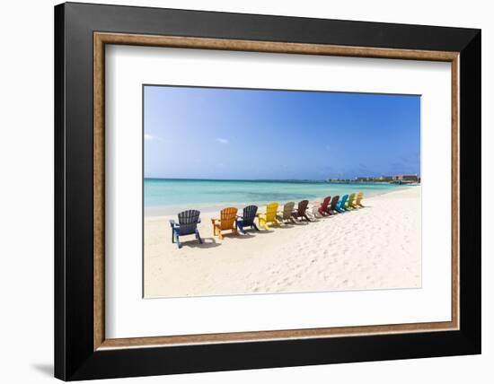 A Row of Colourful Wooden Deckchairs on Palm Beach, Aruba, Netherlands Antilles-Jane Sweeney-Framed Photographic Print