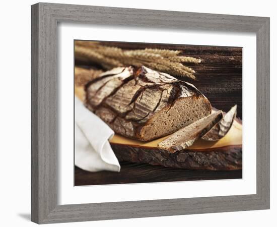 A Rustic Country Loaf on a Slice of Wood-Karl Newedel-Framed Photographic Print
