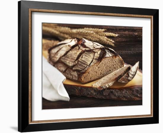 A Rustic Country Loaf on a Slice of Wood-Karl Newedel-Framed Photographic Print