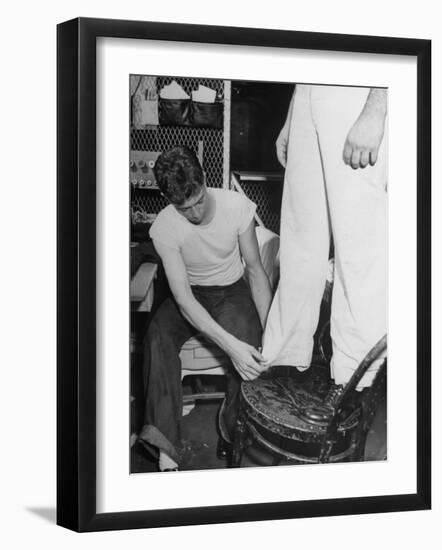 A Sailor in the Tailor Shop Aboard a US Navy Cruiser Checking Uniform Trousers of Another Sailor-null-Framed Photographic Print