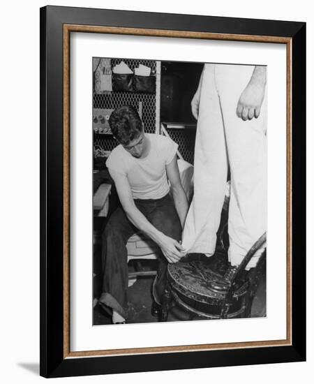 A Sailor in the Tailor Shop Aboard a US Navy Cruiser Checking Uniform Trousers of Another Sailor-null-Framed Photographic Print