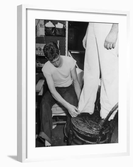 A Sailor in the Tailor Shop Aboard a US Navy Cruiser Checking Uniform Trousers of Another Sailor-null-Framed Photographic Print