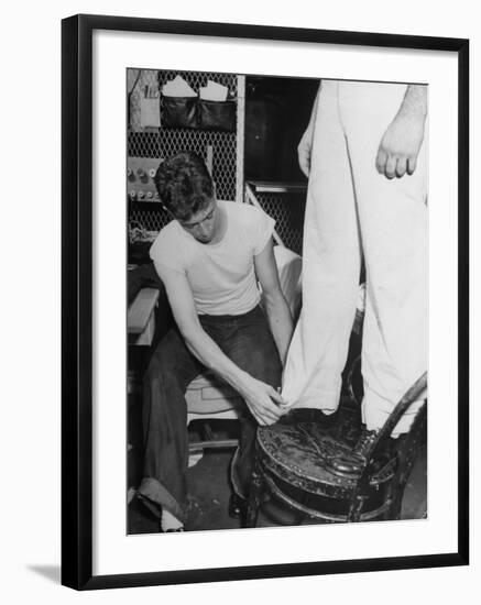 A Sailor in the Tailor Shop Aboard a US Navy Cruiser Checking Uniform Trousers of Another Sailor-null-Framed Photographic Print