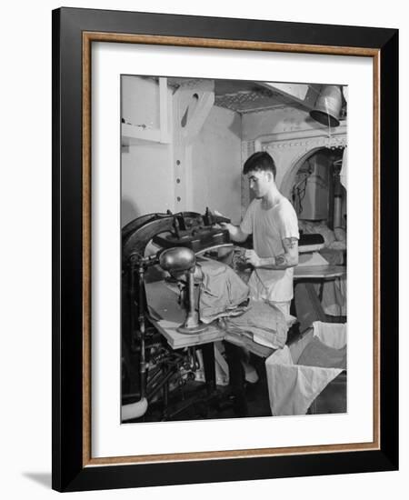 A Sailor Pressing Uniform Trousers in the Tailor Shop of a US Navy Cruiser-null-Framed Photographic Print