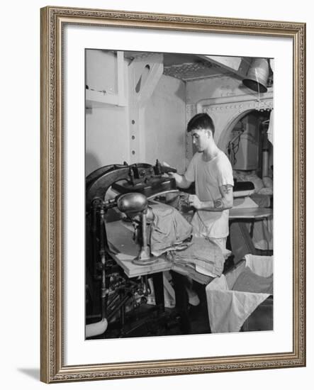 A Sailor Pressing Uniform Trousers in the Tailor Shop of a US Navy Cruiser-null-Framed Photographic Print