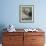 A Sea Otter Looks out from Behind a Rock-null-Framed Photographic Print displayed on a wall