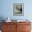 A Sea Otter Looks out from Behind a Rock-null-Framed Photographic Print displayed on a wall