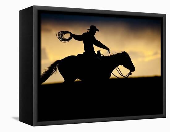 A Silhouetted Cowboy Riding Alone a Ridge at Sunset in Shell, Wyoming, USA-Joe Restuccia III-Framed Premier Image Canvas